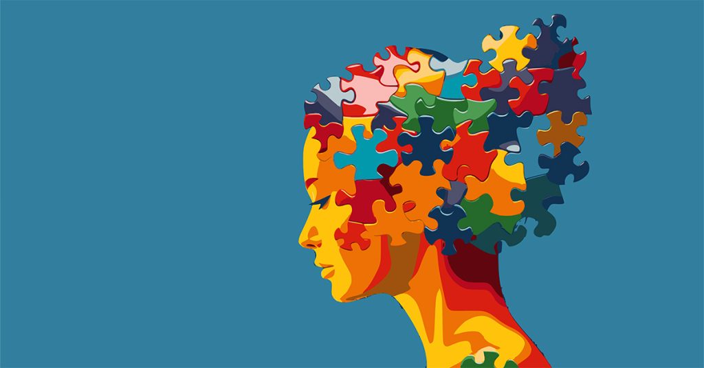 Illustrazione del profilo di una donna neurodivergente, con la testa formata da pezzi di puzzle colorati a incastro su sfondo blu.